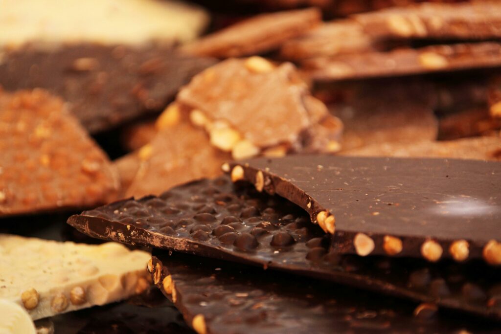 A detailed close-up of assorted gourmet chocolate bars with nuts.